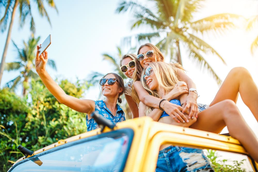 group of expat women share a photo in a car while driving in Phuket